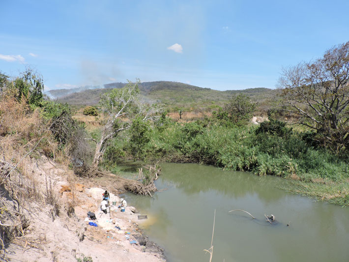 Archaeologists excavate at a site on the bank of Zambia’s Kalambo River where they have discovered the world’s earliest known wooden architecture. (Courtesy Larry Barham)